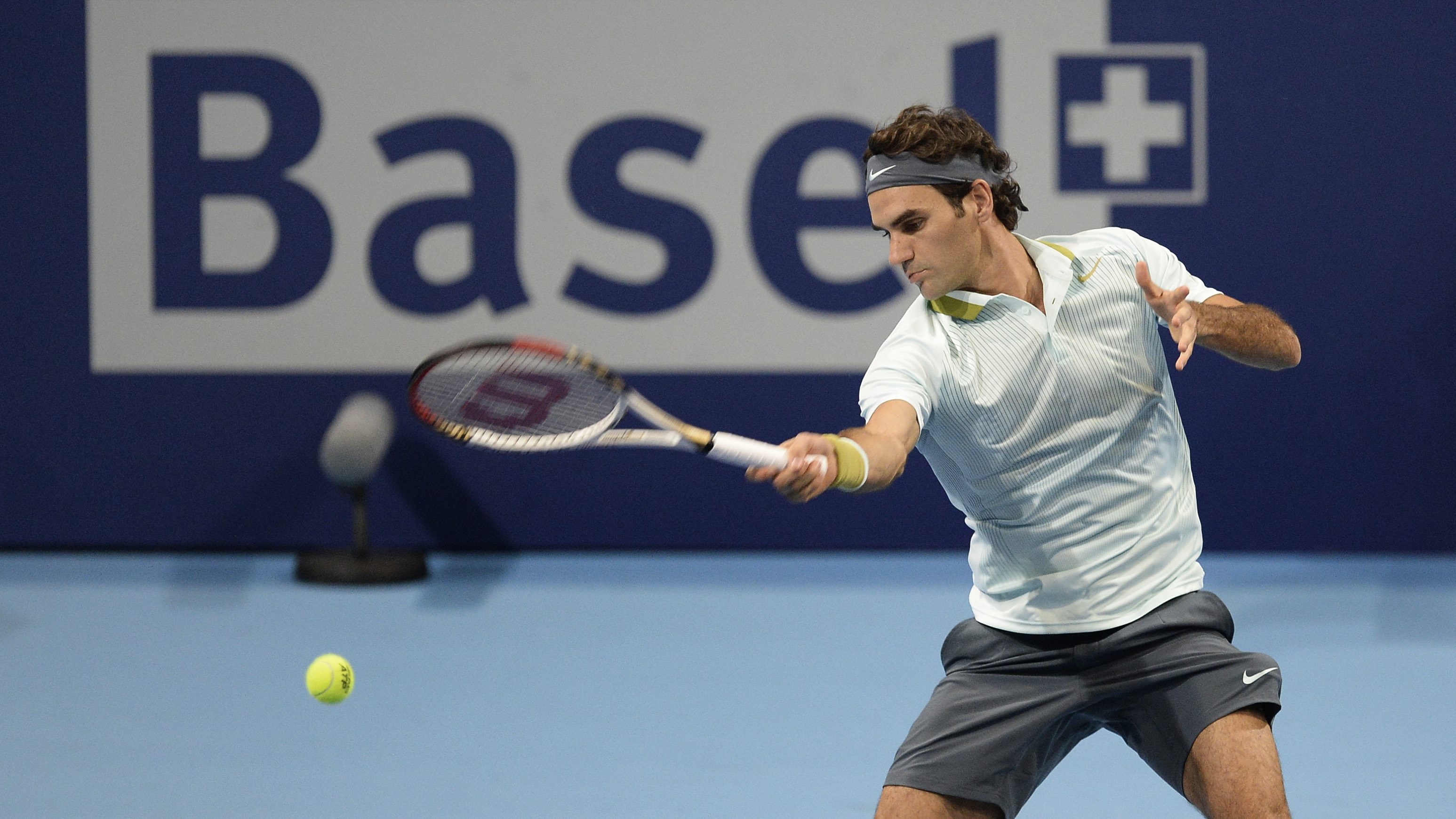 Switzerland's Roger Federer returns a ball to Uzbekistan's Denis Istomin during their second round match at the Swiss Indoors tennis tournament at the St. Jakobshalle in Basel, Switzerland, on Wednesday, Oct. 23, 2013. (AP Photo/Keystone,Georgios Kefalas)