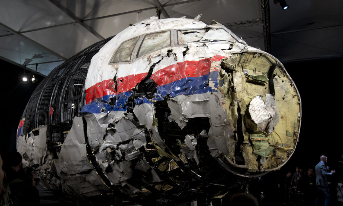 The reconstructed wreckage of Malaysia Airlines Flight MH17 is put on display during a press conference in Gilze-Rijen, central Netherlands, Tuesday, Oct. 13, 2015.  Malaysia Airlines Flight 17 broke up high over Eastern Ukraine killing all 298 people on board. (AP Photo/Peter Dejong)