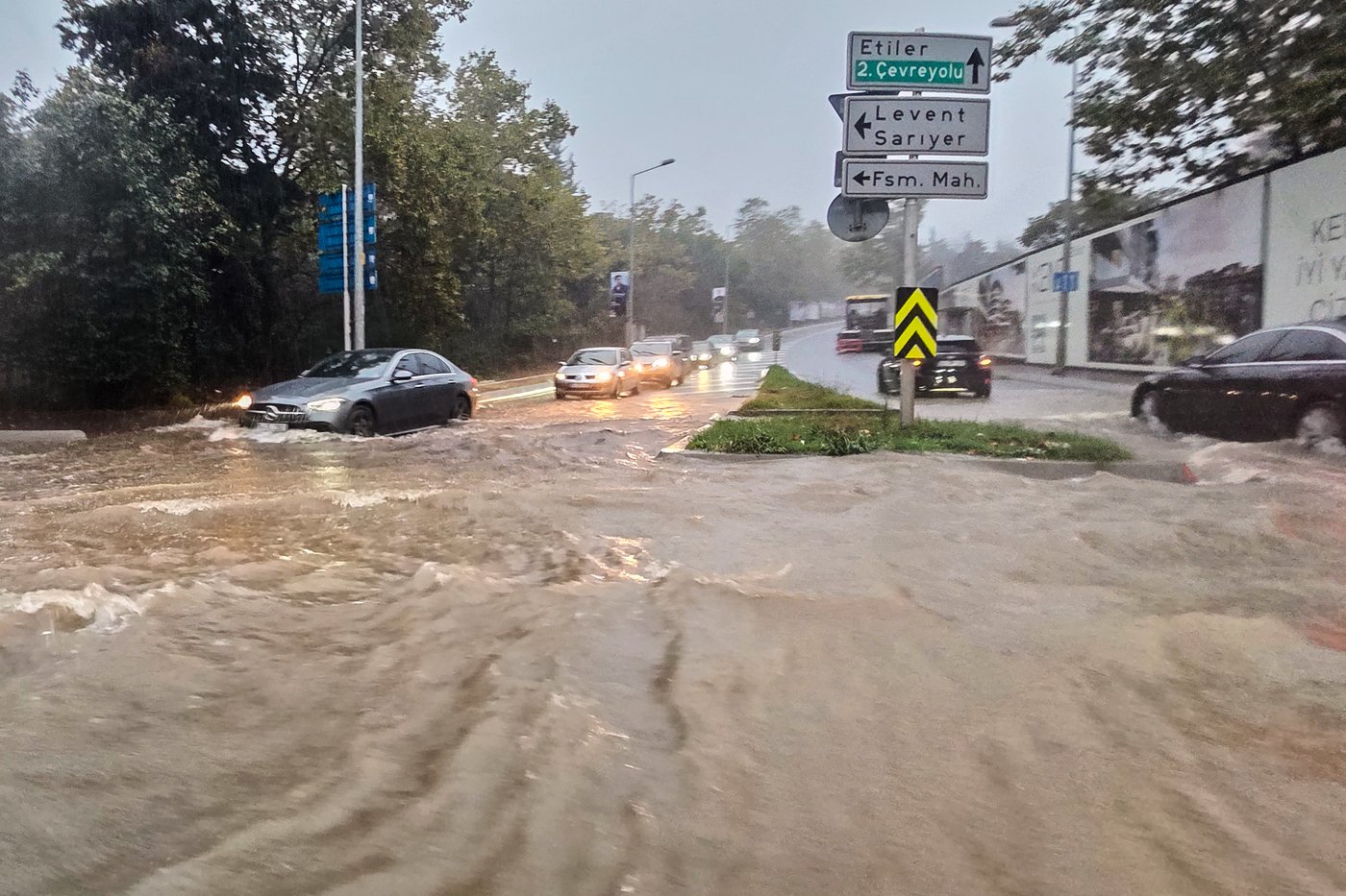 Vehicles drive along a partially flooded road during a heavy rain in Istanbul, Turkey, Wednesday, Oct. 14, 2026. (Omer Hamza Yildiz/DIA Photo via AP)
