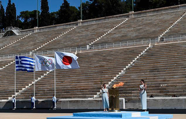 Greece hands over the Olympic flame to Tokyo in empty stadium