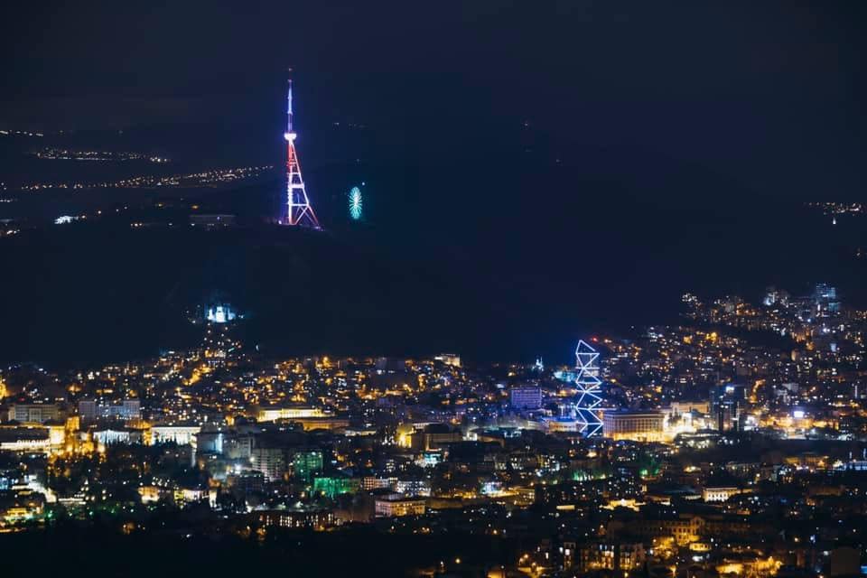 The Tbilisi TV tower lit up with the colors of the US flag