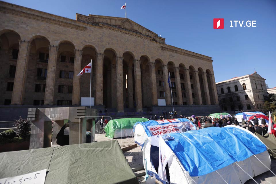Opposition supporters set up another tent at parliament