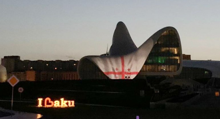 Heydar Aliyev Center in Baku lit in Georgian national flag colors