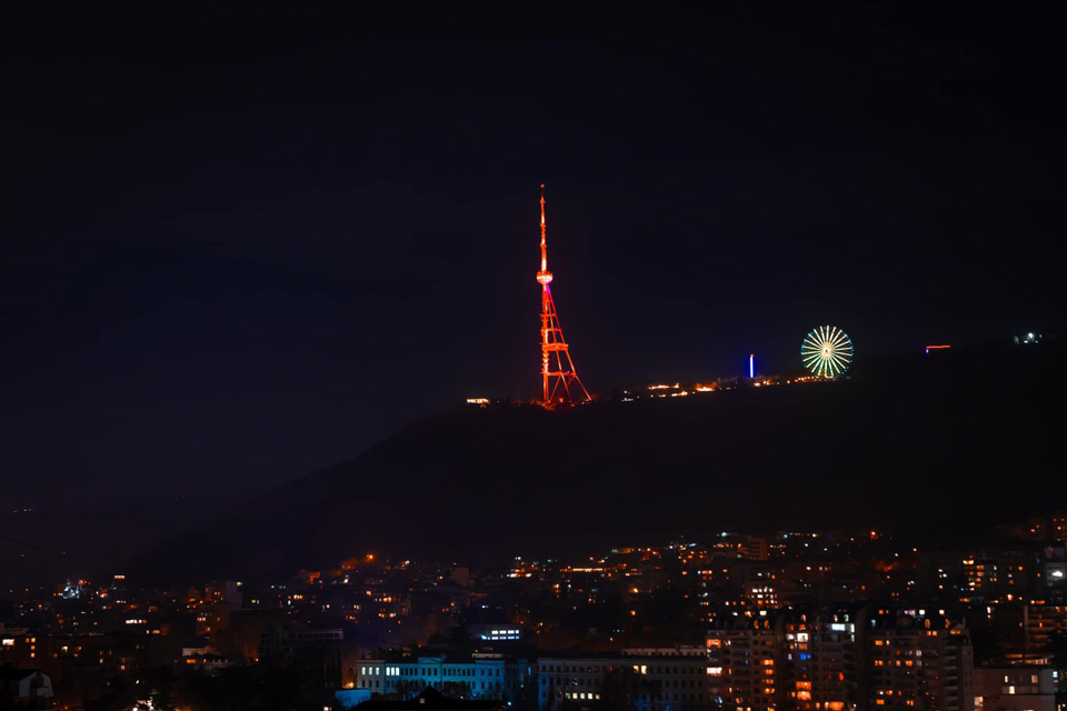 Tbilisi TV Tower lit in orange color