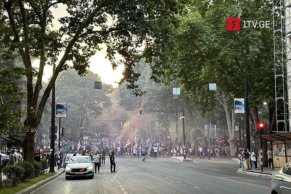 Rally participants march toward parliament building