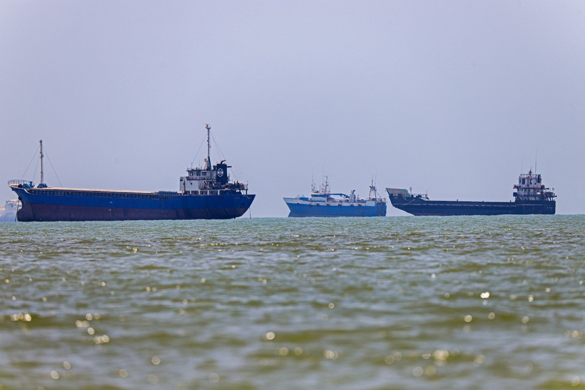 In this picture obtained from Iran's ISNA news agency on June 18, 2026, vessels are seen anchored in Bandar Abbas along the Strait of Hormuz. Oil prices tumbled after Trump and his Iranian counterpart separately signed their accord to end the Middle East war, with the Strait of Hormuz to reopen but two months of negotiations lying ahead. (Photo by AMIRHOSSEIN KHORGOOEI / ISNA / AFP) /